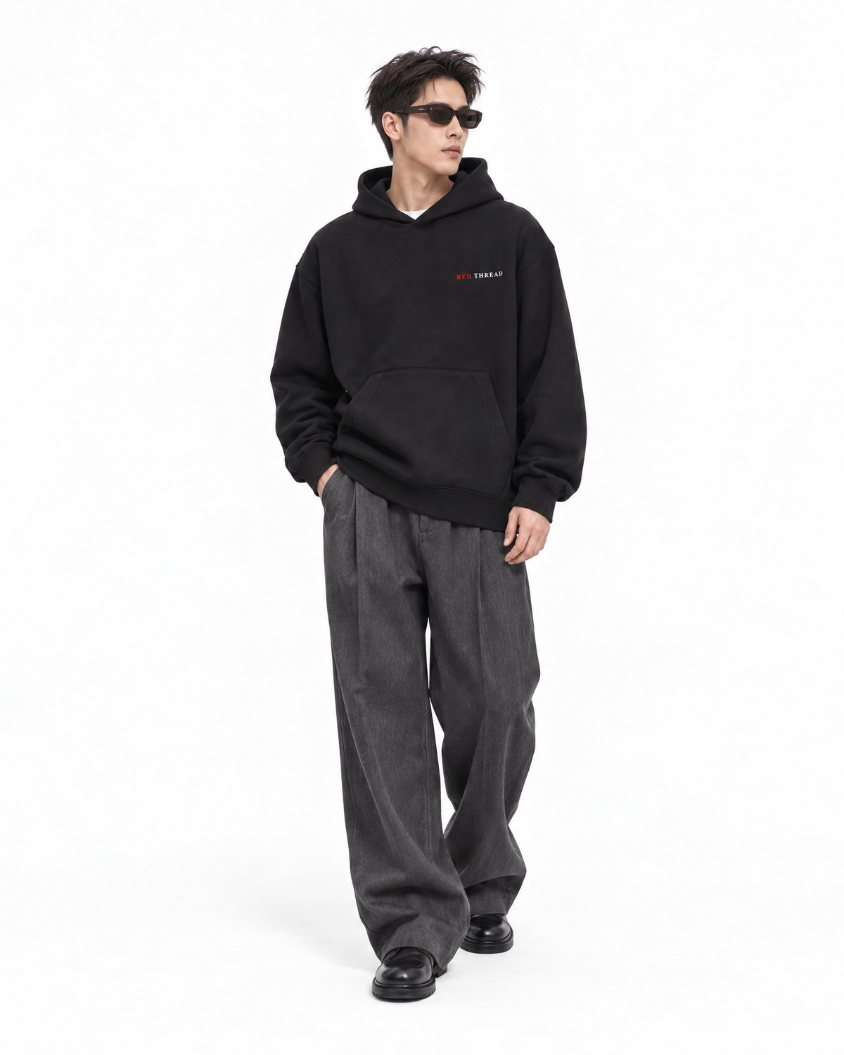male model wearing Red Thread Character over Status hoodie in black