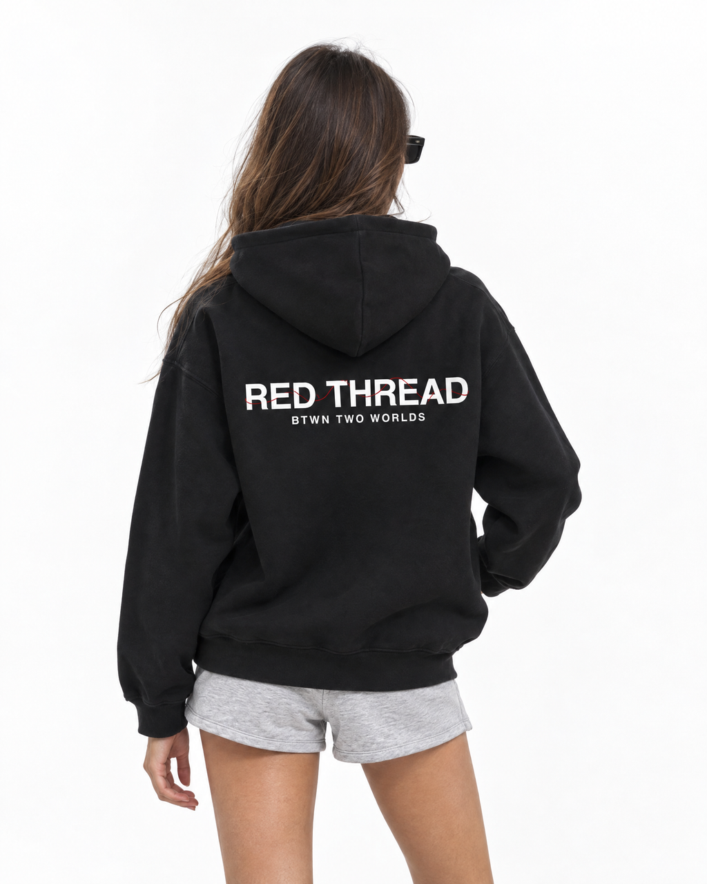 Red Thread Between Two Worlds hoodie in black, worn by a female model