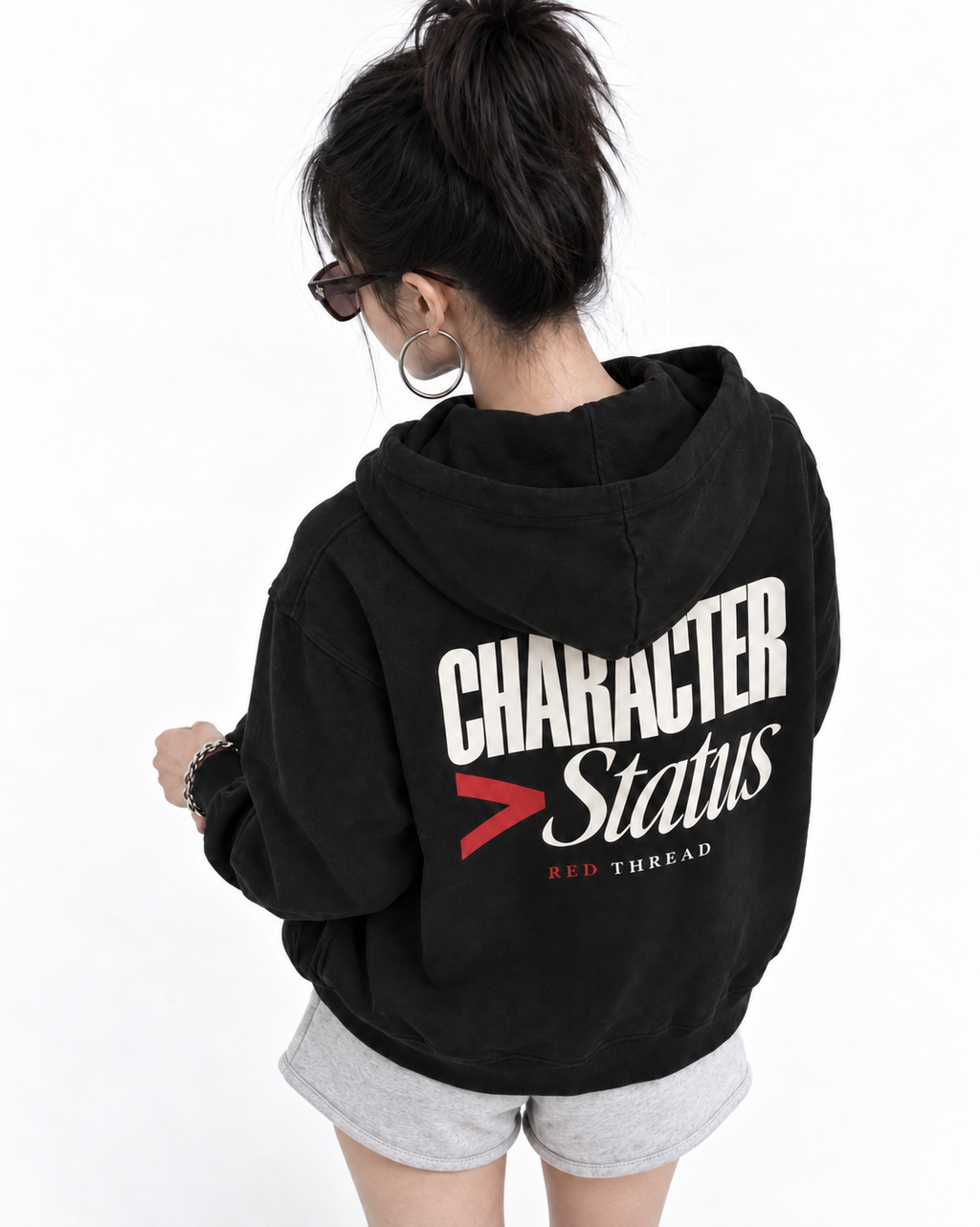 Female model wearing Red Thread Character over Status hoodie in black
