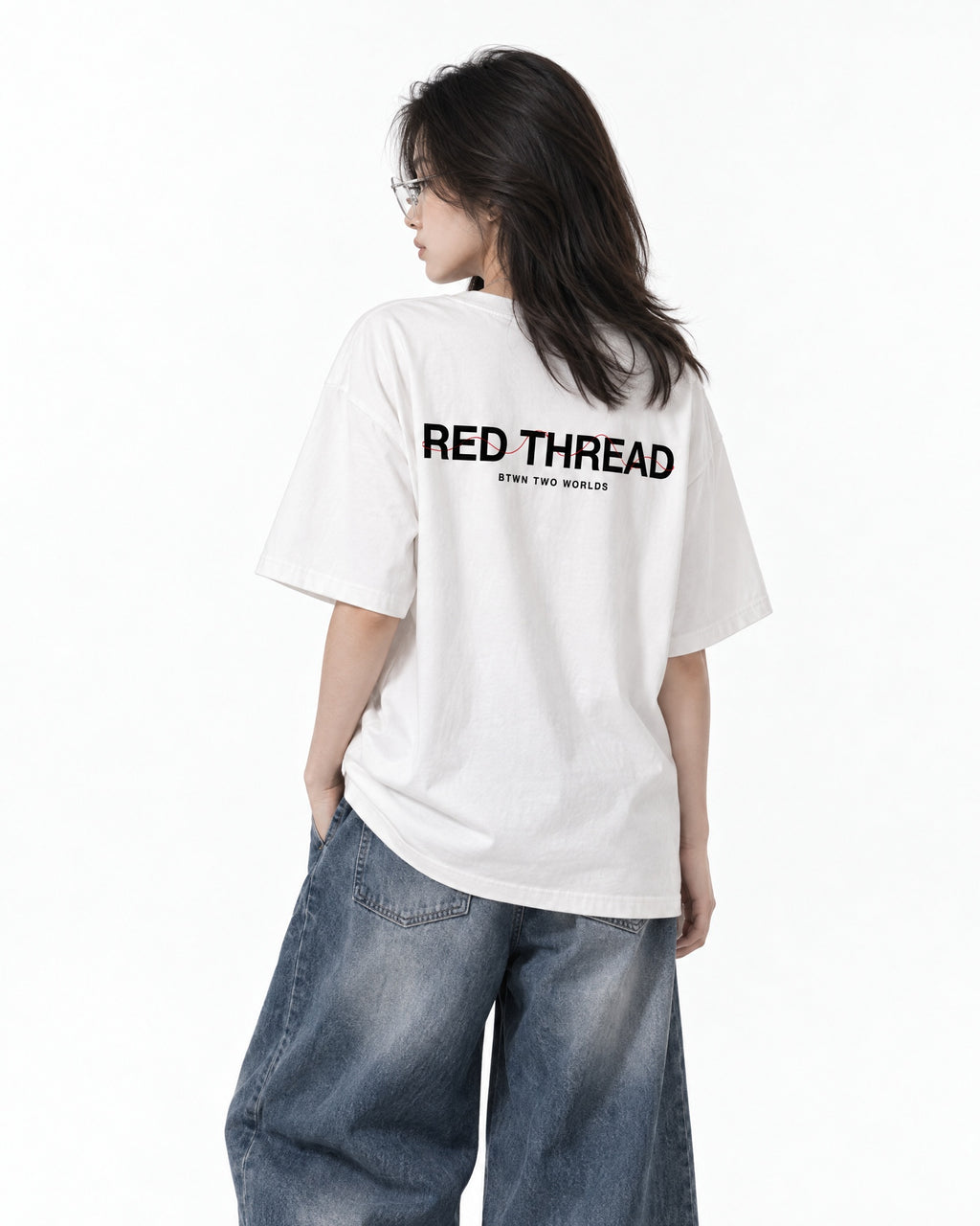 Red Thread Between Two Worlds heavyweight tee in white, worn by a female model