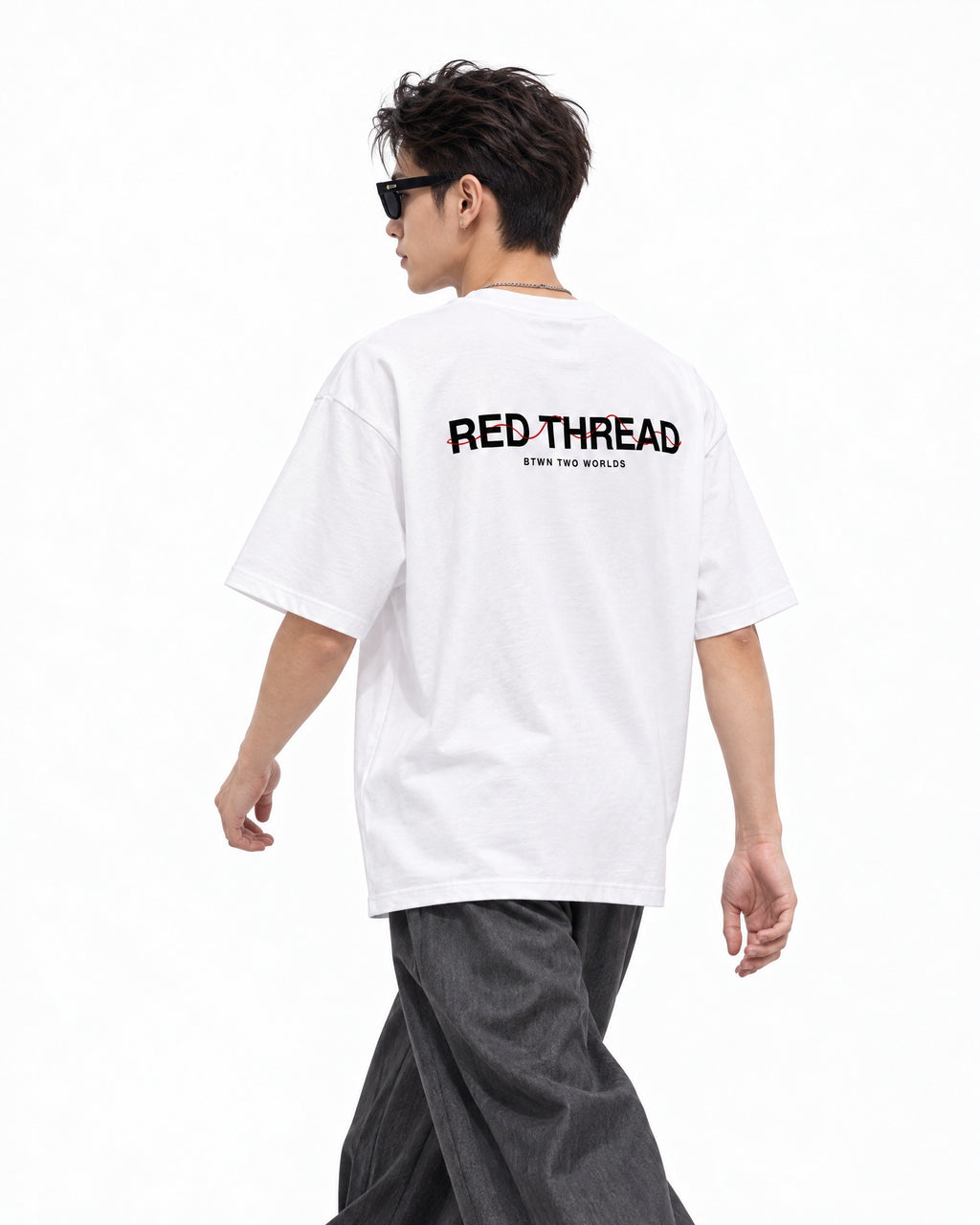 Red Thread Between Two Worlds heavyweight tee in white, worn by a male model