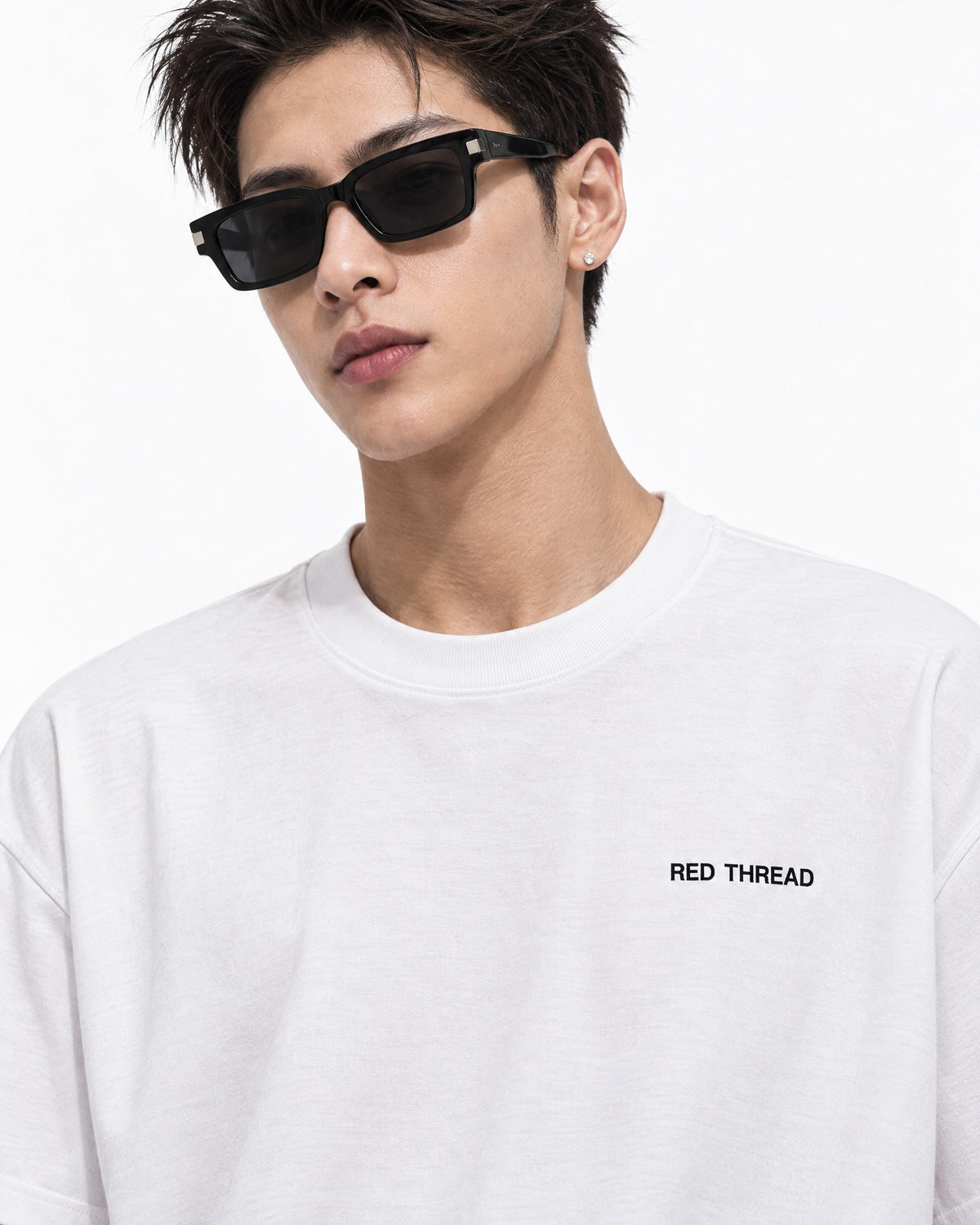 Red Thread Between Two Worlds heavyweight tee in white, worn by a male model