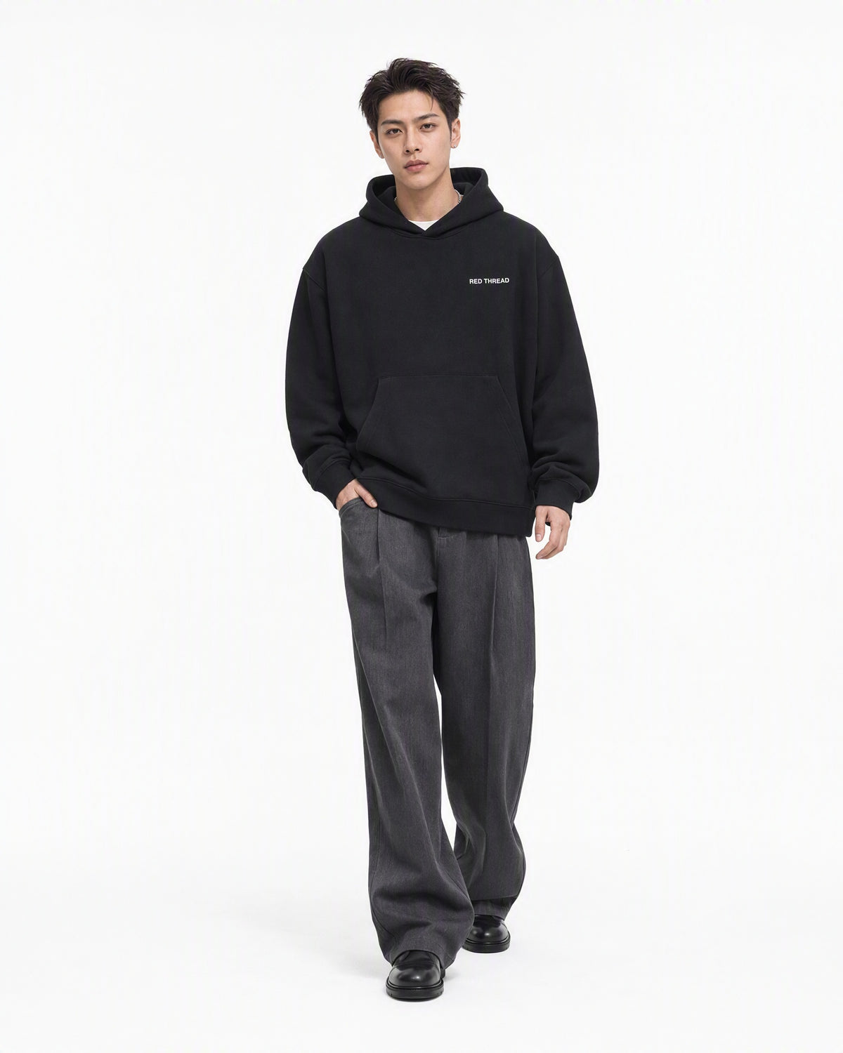 Red Thread Between Two Worlds hoodie in black, worn by a male model
