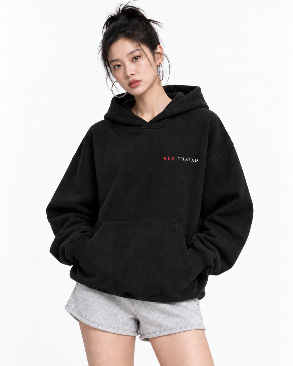 Female model wearing Red Thread Character over Status hoodie in black