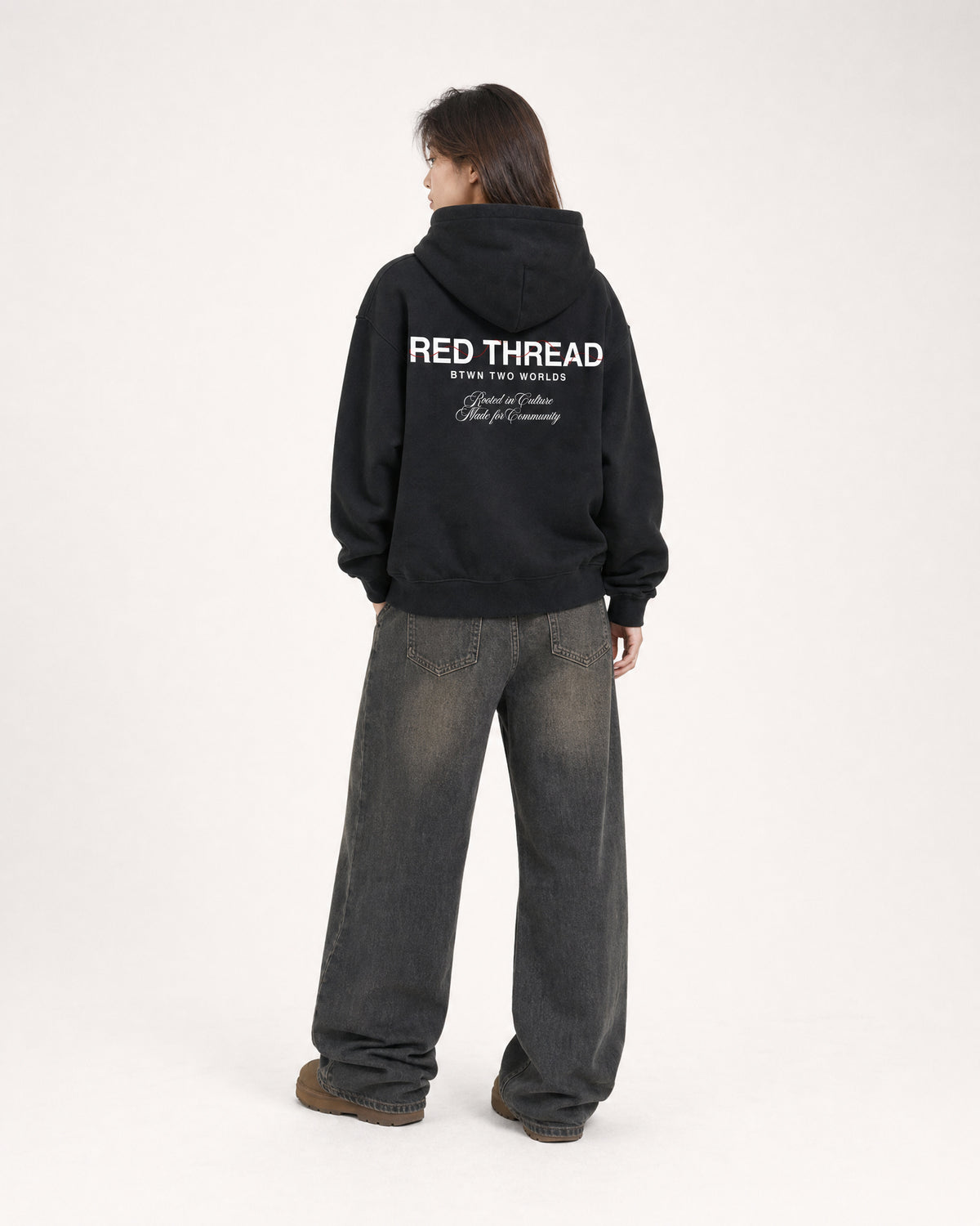 Red Thread Rooted In Culture hoodie in black, worn by a female model