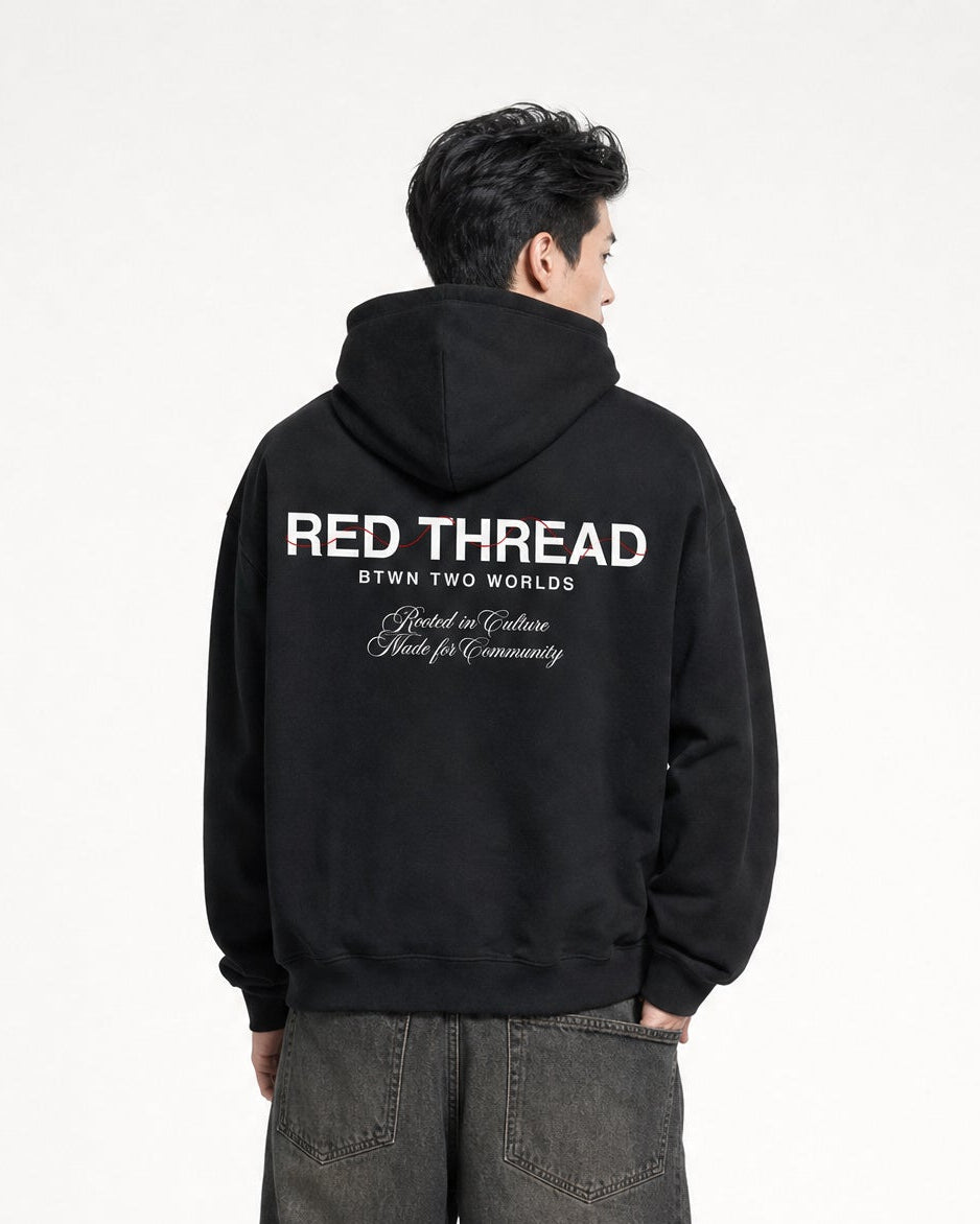 Red Thread Rooted In Culture hoodie in black, worn by a male model