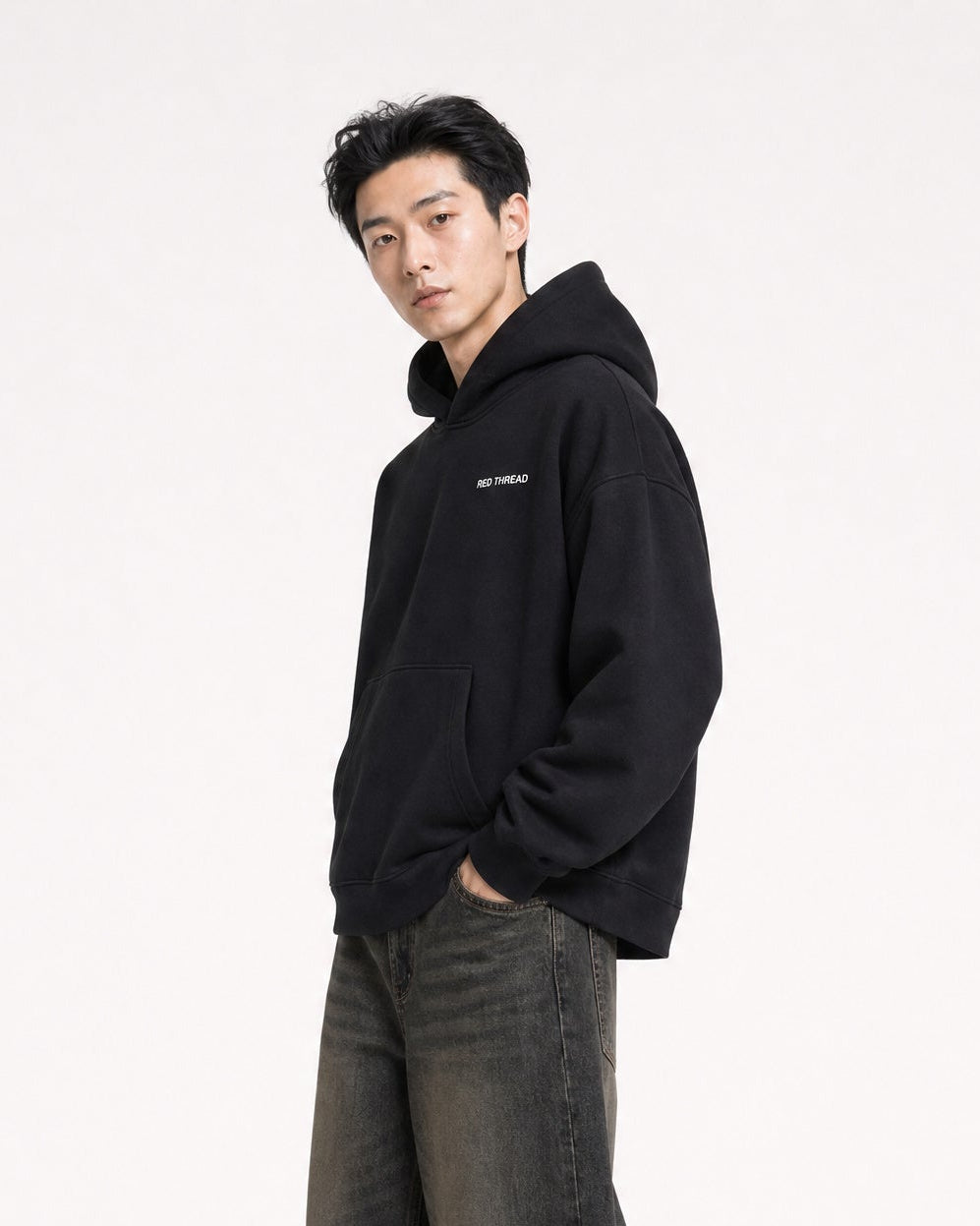 Red Thread Rooted In Culture hoodie in black, worn by a male model
